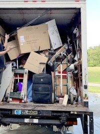 a man standing in the back of a moving truck